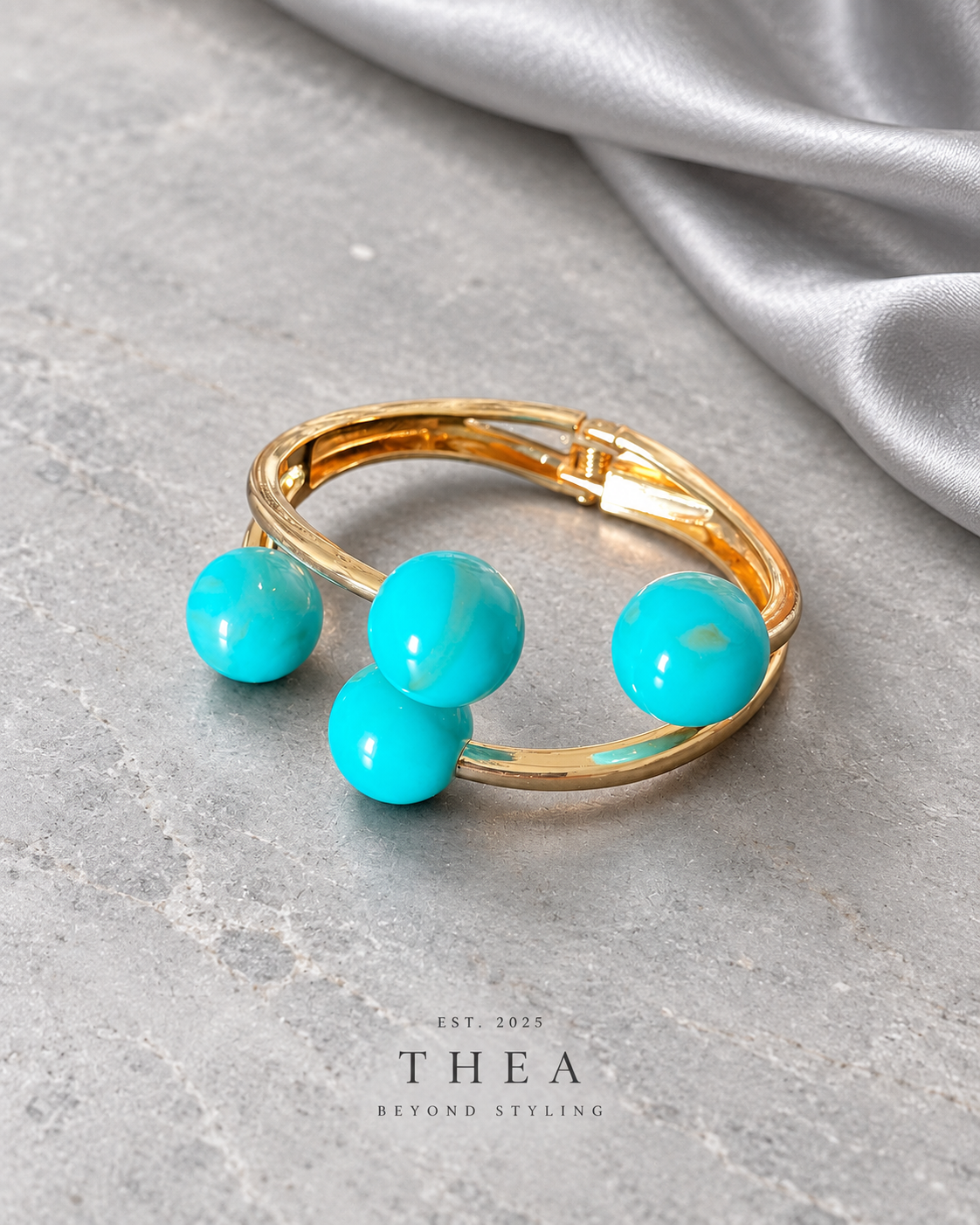 Azure Orbit Cuff with turquoise blue spheres and gold-tone band
