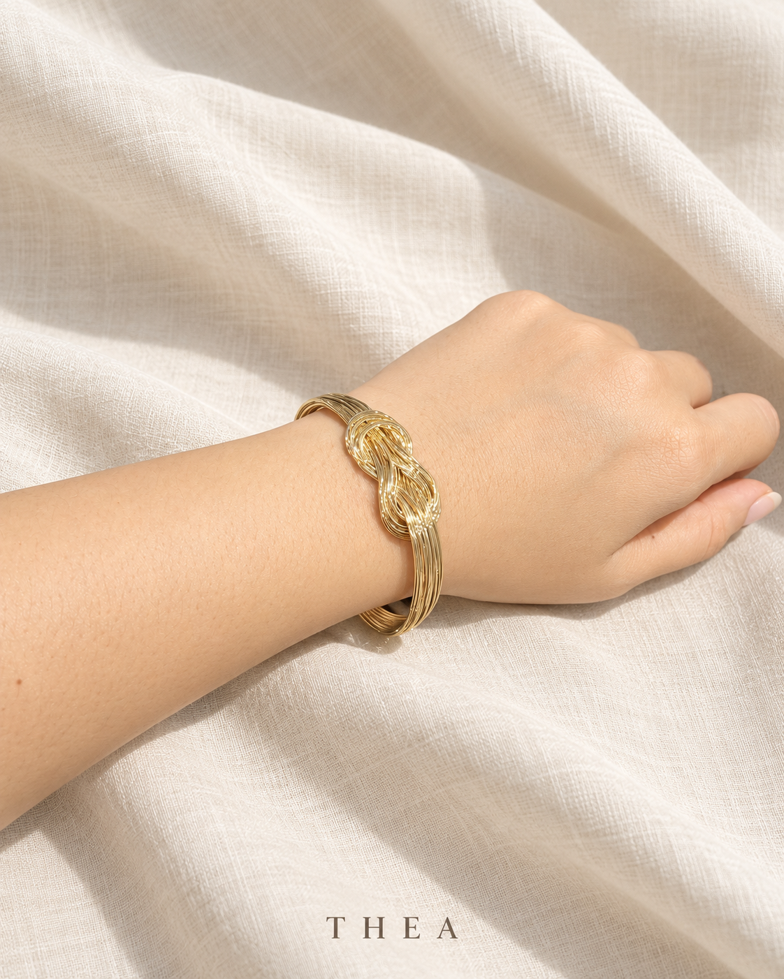 Golden Thread Bangle with gold-tone interwoven knot
