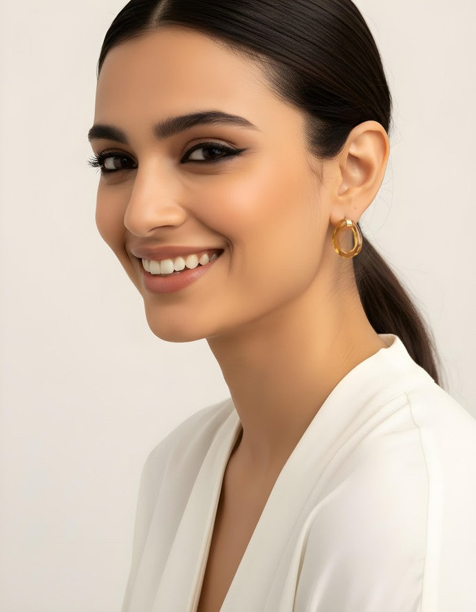 Glossy grey Lucent Loop Earrings styled on a magazine page