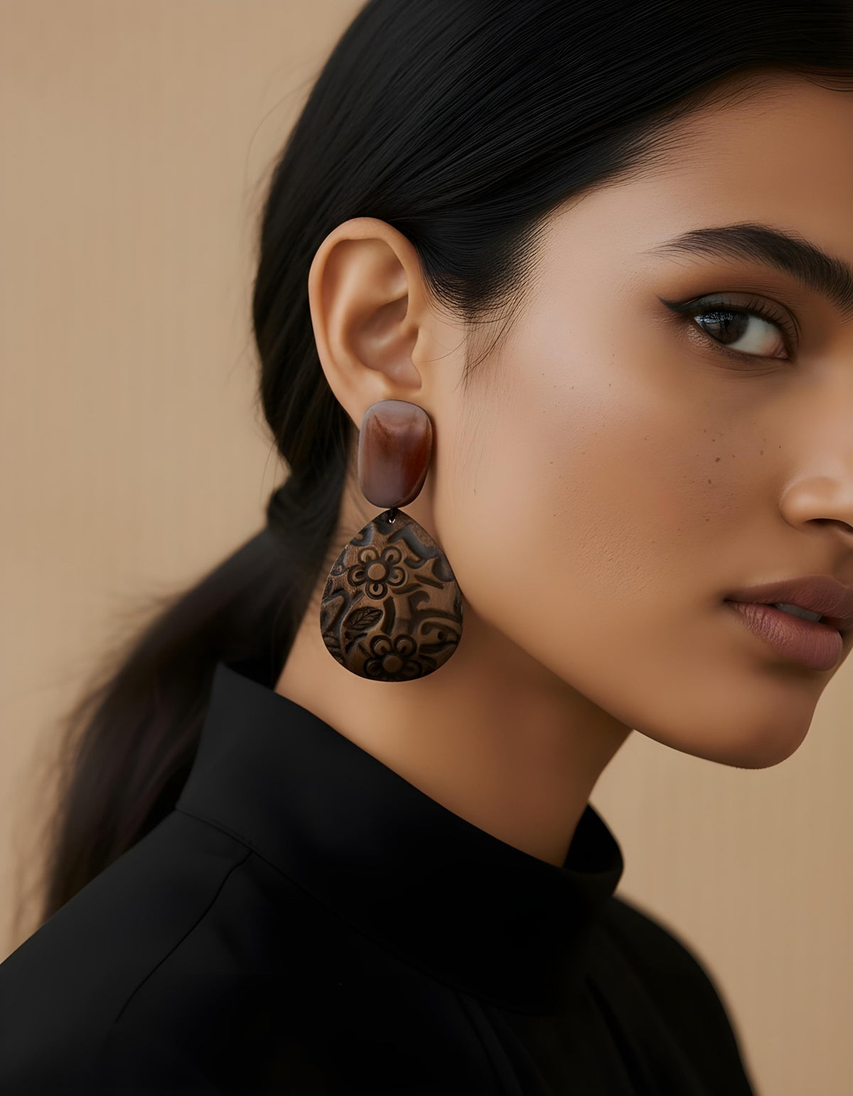 Model wearing Terra Bloom Earrings with natural wood studs and engraved floral teardrop pendants