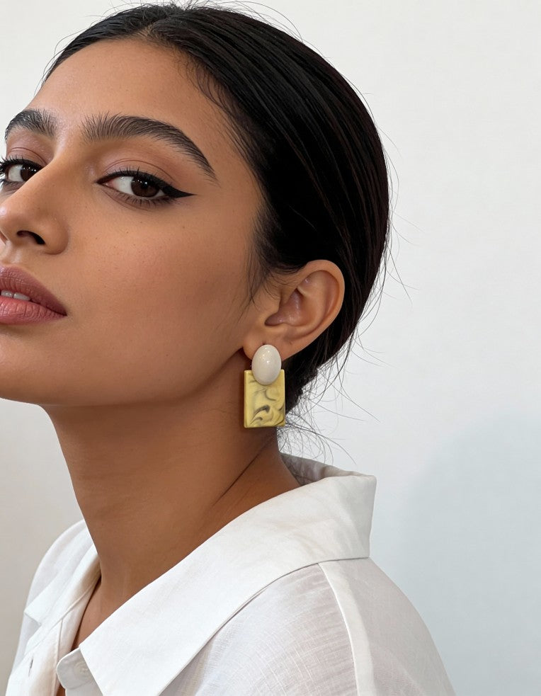 Model wearing ice blue marble-inspired Palette Block Earrings